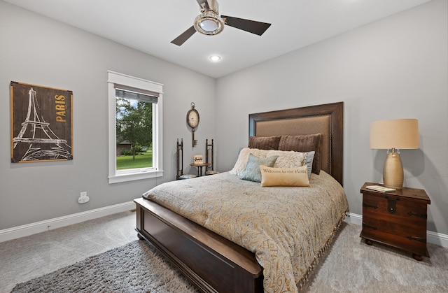 bedroom with ceiling fan and light colored carpet