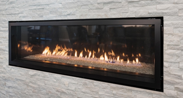 interior details with a stone fireplace