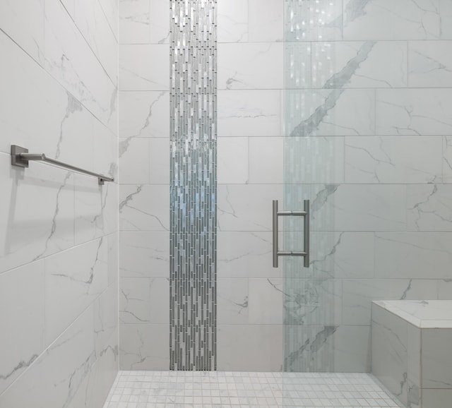 bathroom featuring a shower with door