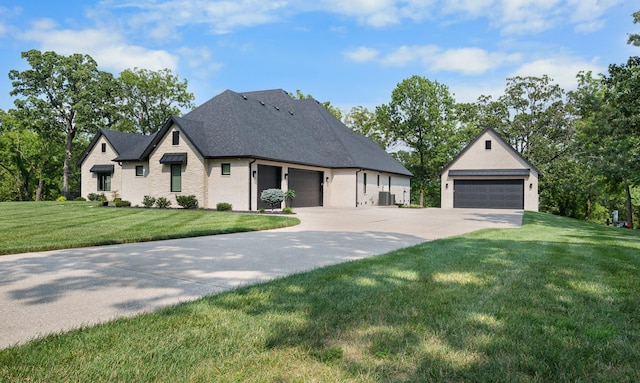 french country style house with a front lawn, cooling unit, and a garage