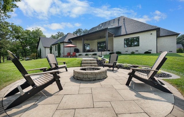 back of property with an outdoor fire pit, a patio, and a yard