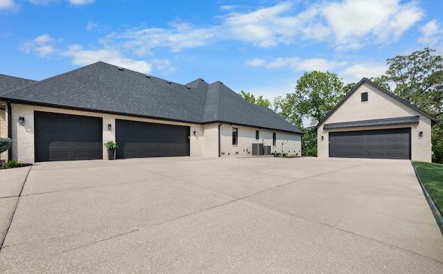 view of front of property featuring cooling unit and a garage