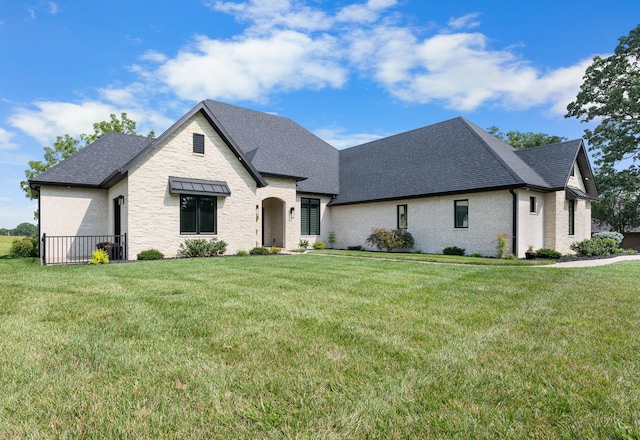 french country home featuring a front yard