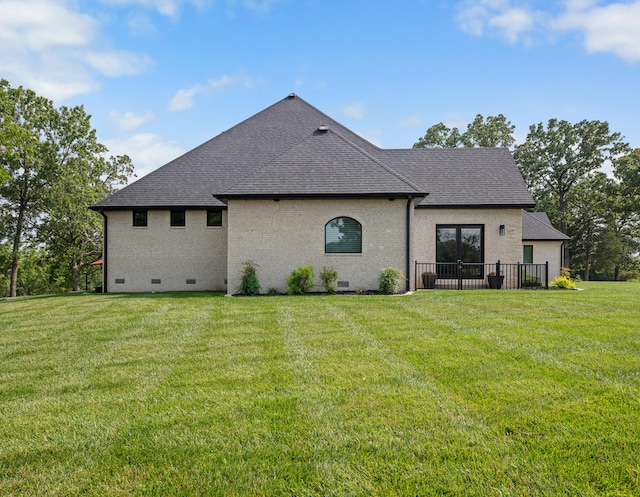 back of property featuring a yard