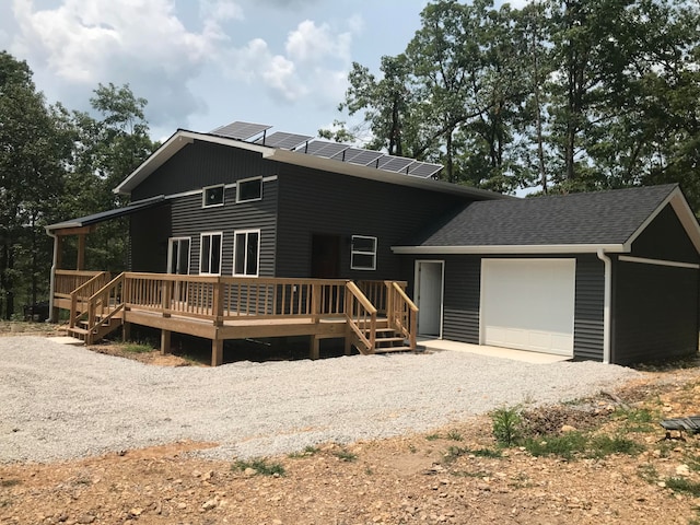 view of front of home featuring a garage and a deck