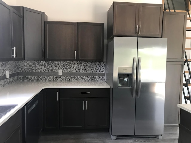 kitchen with stainless steel fridge, decorative backsplash, hardwood / wood-style floors, and dishwasher