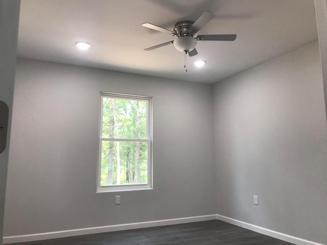 empty room featuring ceiling fan and dark hardwood / wood-style floors