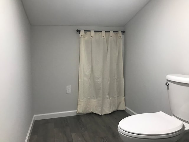 bathroom with wood-type flooring and toilet