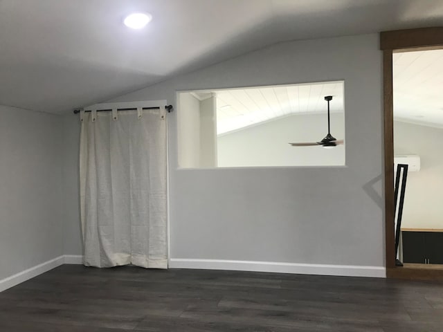 empty room with lofted ceiling, ceiling fan, and dark hardwood / wood-style flooring