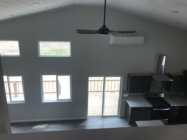 living room featuring an AC wall unit, ceiling fan, and a wealth of natural light