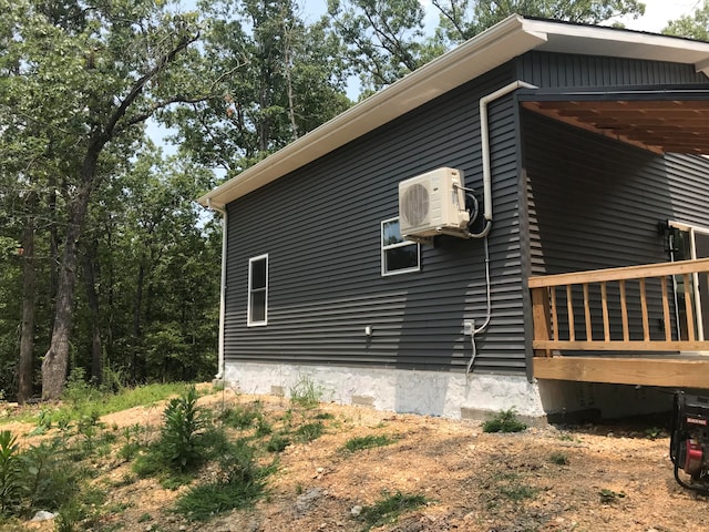 view of side of home with ac unit