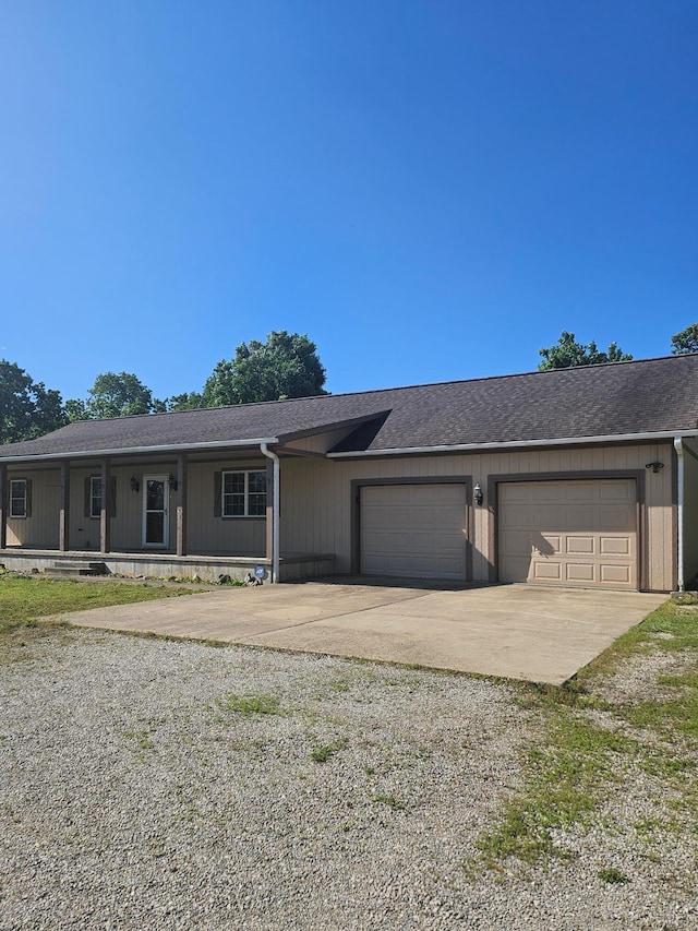 7186 US Highway 60, Mountain View, MO 65548 - view of front facade featuring concrete driveway, a garage, a shingled roof, and covered porch