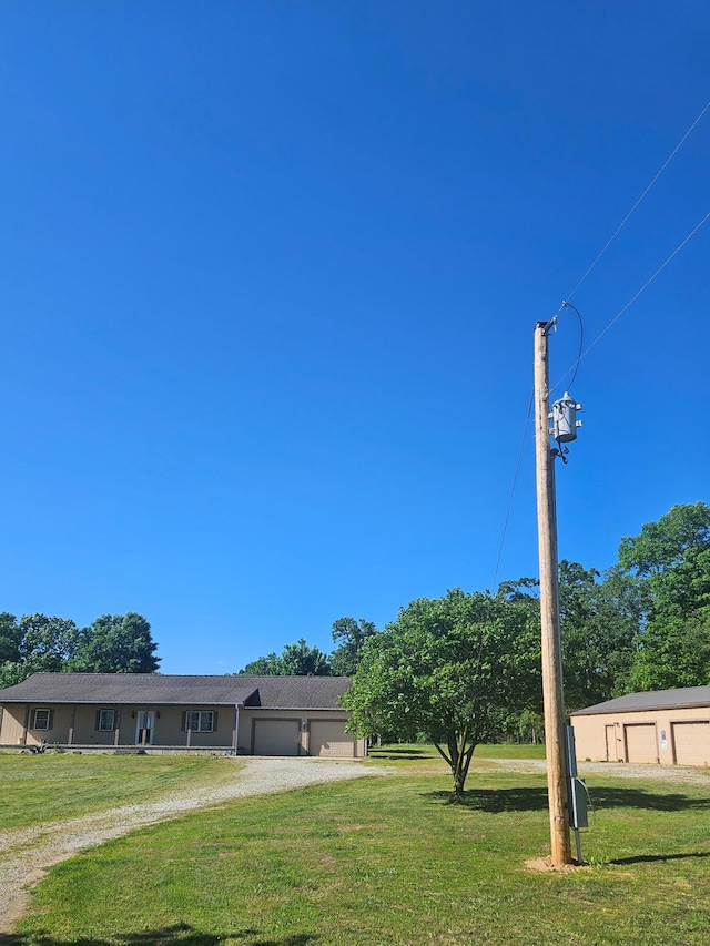 7186 US Highway 60, Mountain View, MO 65548 - view of green lawn featuring a garage and dirt driveway