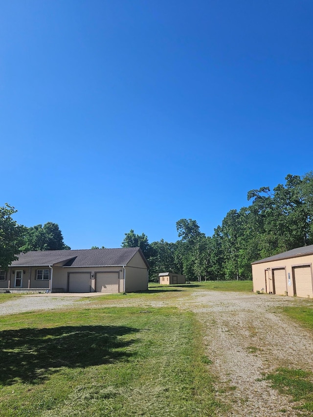 7186 US Highway 60, Mountain View, MO 65548 - view of grassy yard with a garage and driveway