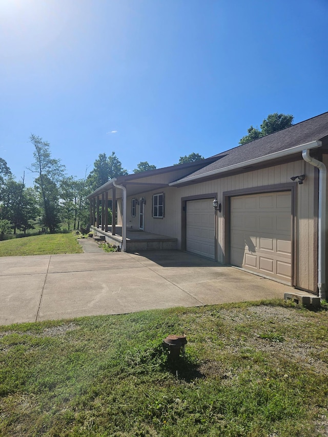 7186 US Highway 60, Mountain View, MO 65548 - view of home's exterior with an attached garage, concrete driveway, covered porch, and a lawn