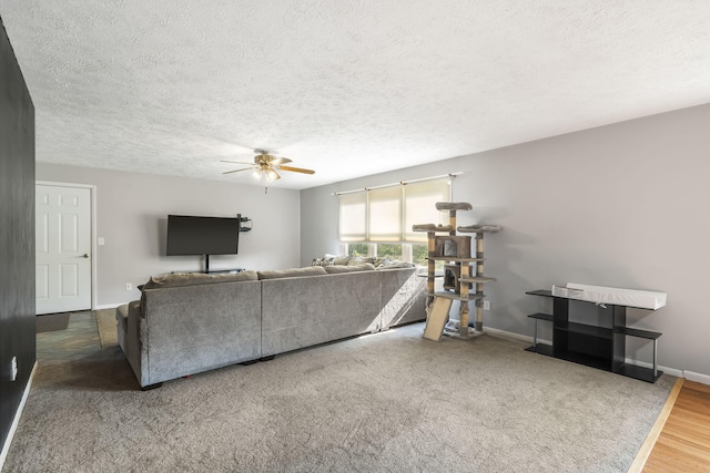 unfurnished living room with ceiling fan, hardwood / wood-style flooring, and a textured ceiling