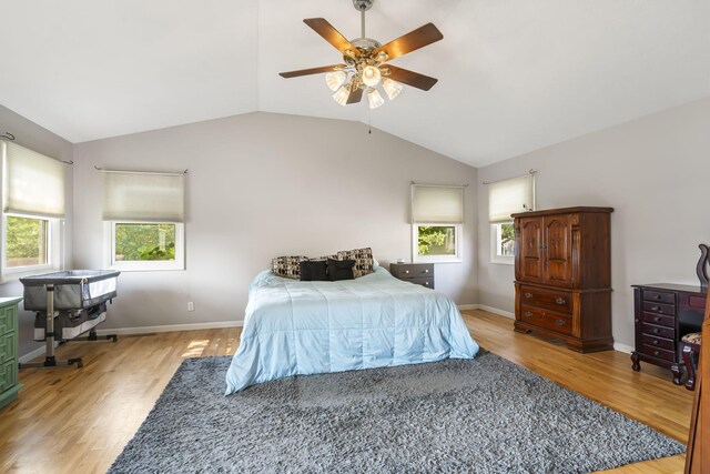 bedroom with light wood-type flooring, ceiling fan, and lofted ceiling