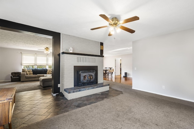 living room featuring dark colored carpet, a textured ceiling, and ceiling fan