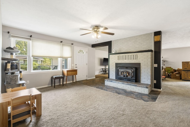 carpeted living room featuring ceiling fan and a textured ceiling