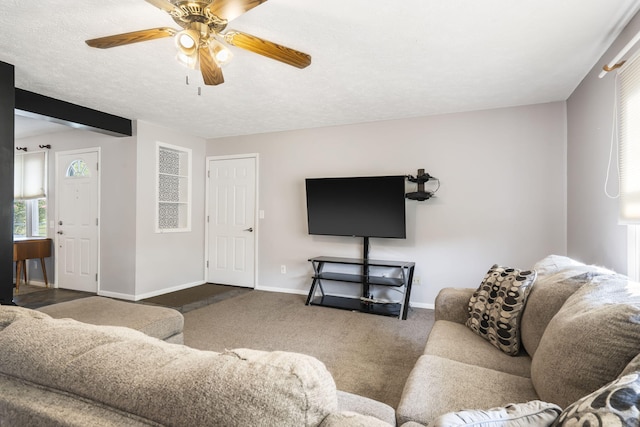 living room with dark carpet, a textured ceiling, and ceiling fan