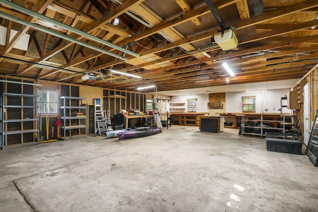 garage featuring a garage door opener and a workshop area