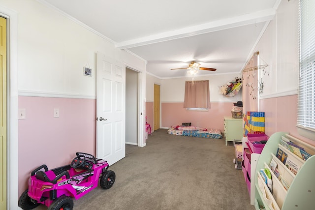 playroom featuring carpet floors, a wealth of natural light, crown molding, and ceiling fan