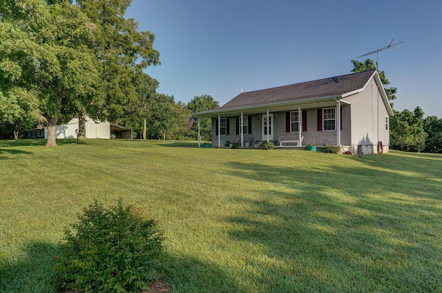 view of front facade featuring a front lawn and covered porch