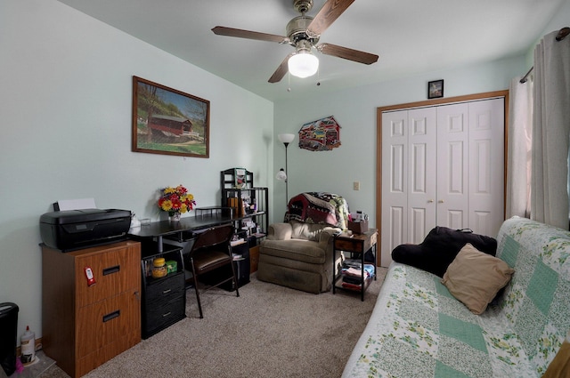 carpeted home office featuring ceiling fan