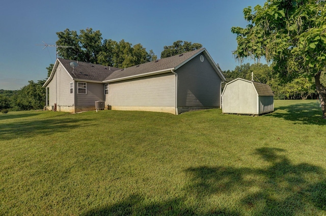 exterior space featuring a yard, a storage unit, and central air condition unit