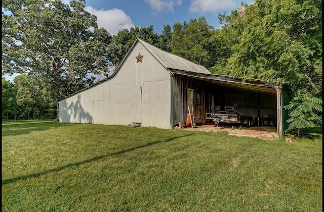 view of outbuilding featuring a yard