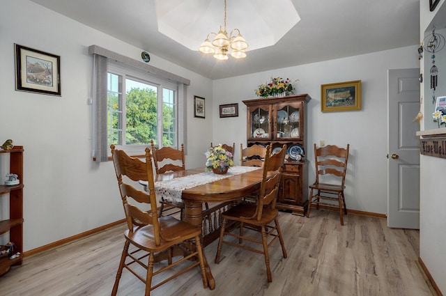 dining area featuring a chandelier and light hardwood / wood-style flooring