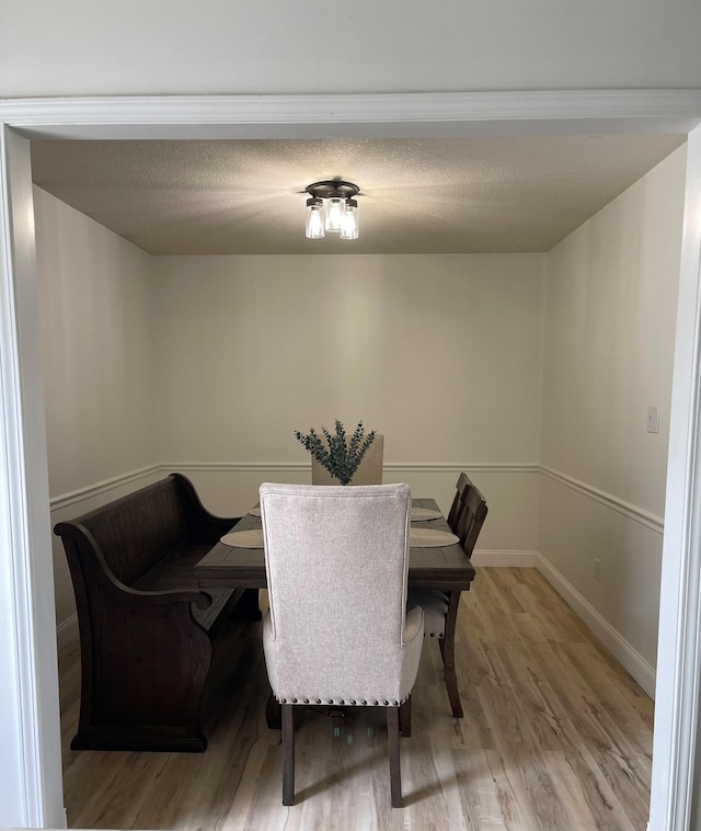 dining space with hardwood / wood-style floors