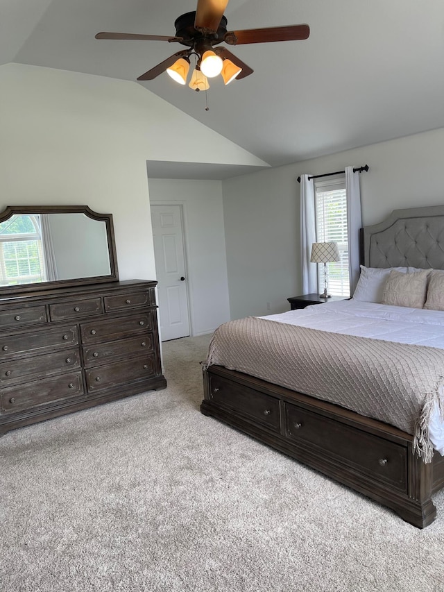 carpeted bedroom featuring ceiling fan and lofted ceiling