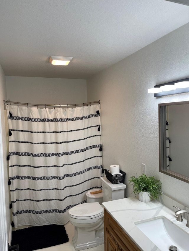 bathroom with curtained shower, vanity, and toilet