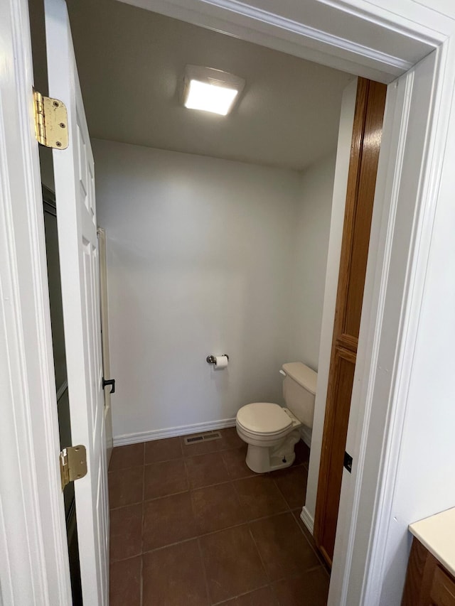 bathroom featuring vanity, toilet, and tile patterned floors