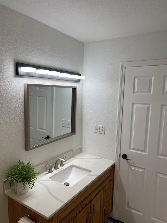 bathroom with vanity and a textured ceiling