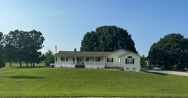 single story home with a porch and a front yard