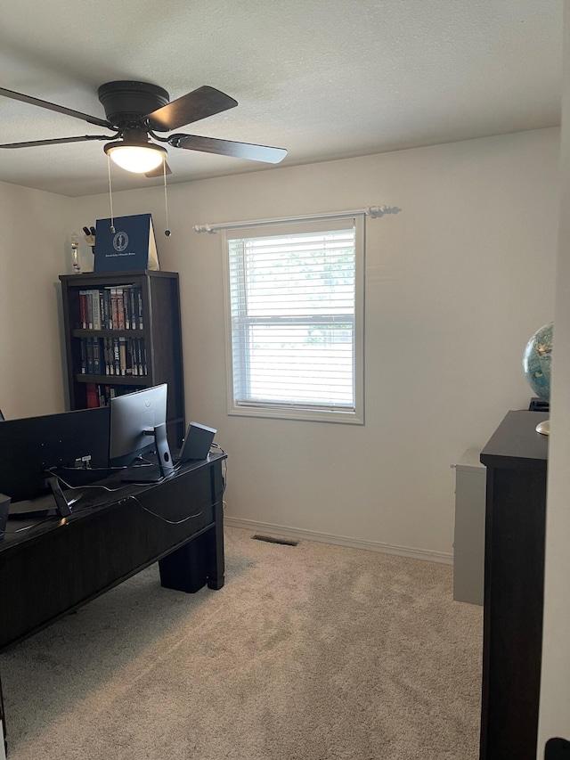 office area with ceiling fan and carpet