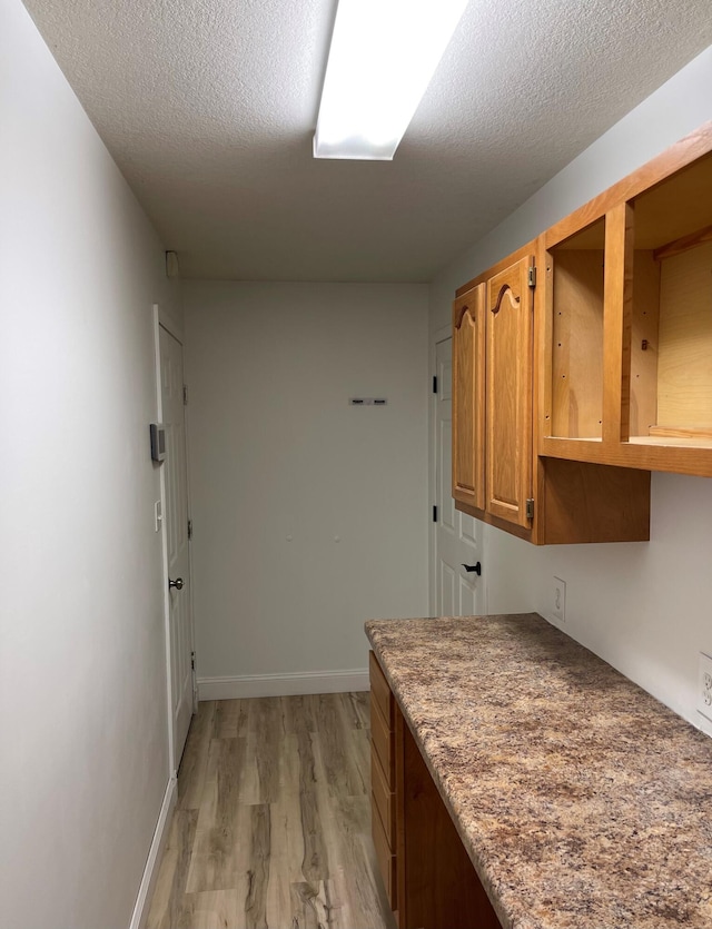 interior space featuring a textured ceiling and light hardwood / wood-style floors