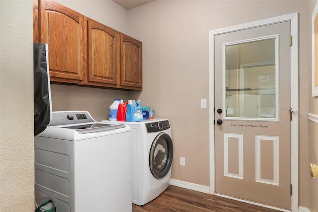 laundry area with washer and clothes dryer, cabinets, and dark hardwood / wood-style floors