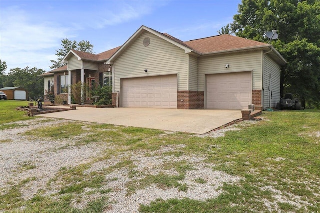 ranch-style house featuring a front yard and a garage