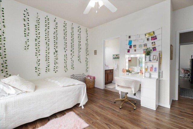 bedroom with ceiling fan, connected bathroom, and dark hardwood / wood-style flooring