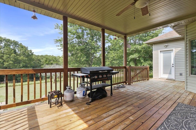 wooden deck with a yard, ceiling fan, and grilling area