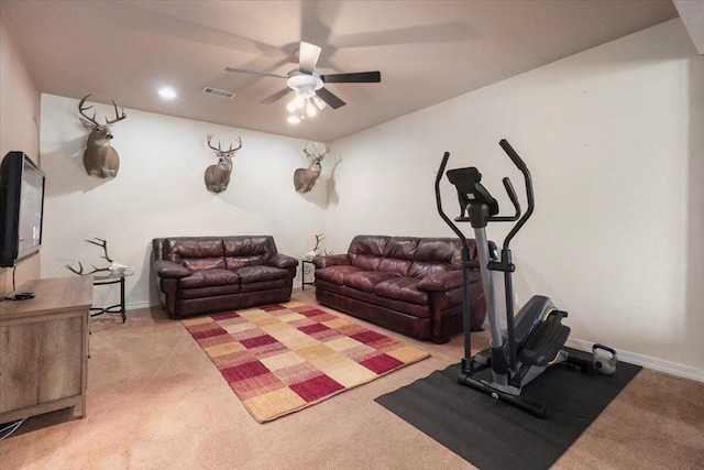 exercise room featuring ceiling fan and light carpet