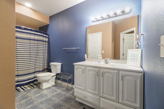 bathroom with tile patterned floors, vanity, and toilet