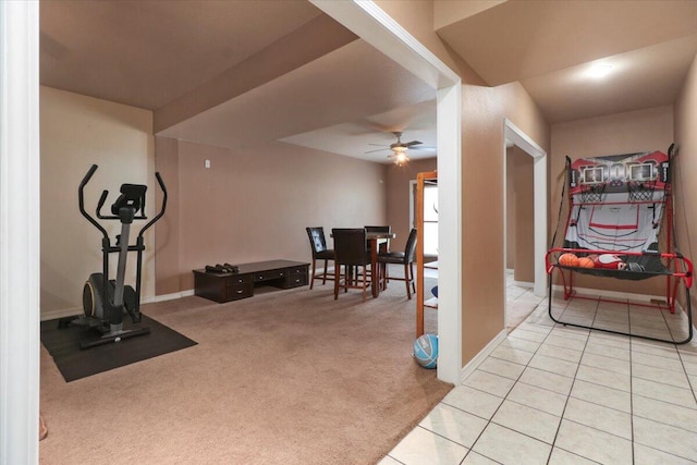 exercise room featuring light carpet and ceiling fan