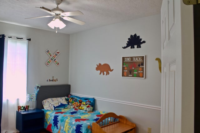 bedroom with a textured ceiling and ceiling fan