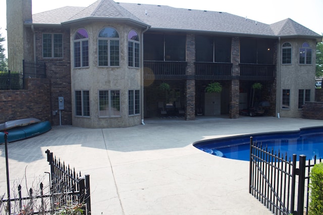 outdoor pool featuring fence and a patio area