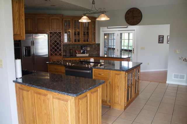 kitchen featuring a kitchen island, black range with electric cooktop, hanging light fixtures, stainless steel refrigerator with ice dispenser, and light tile patterned floors