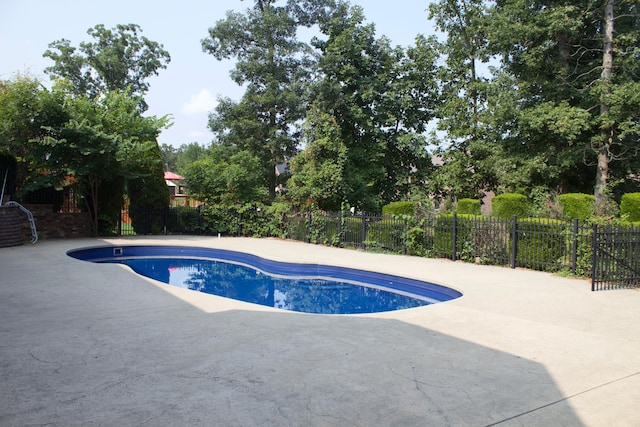 view of swimming pool featuring a fenced in pool, a patio, and fence